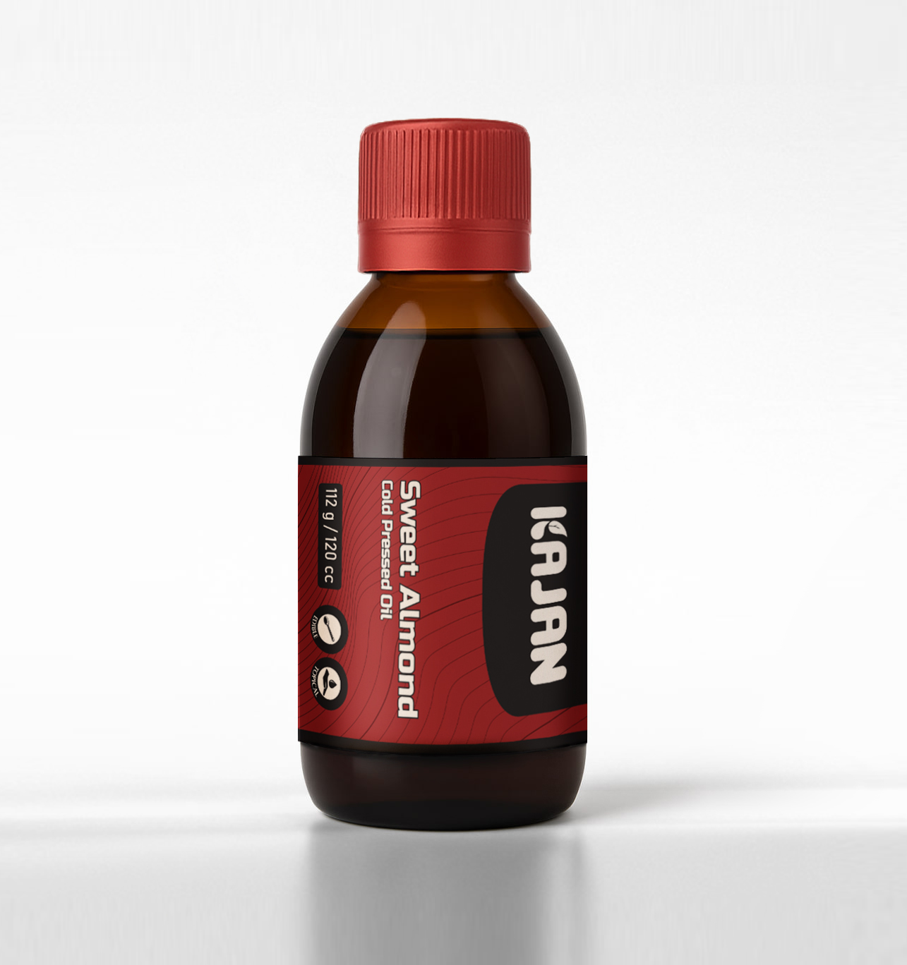 Transparent bottle of KAJAN 100% pure sweet almond oil with a red label and white cap, set against a white background.