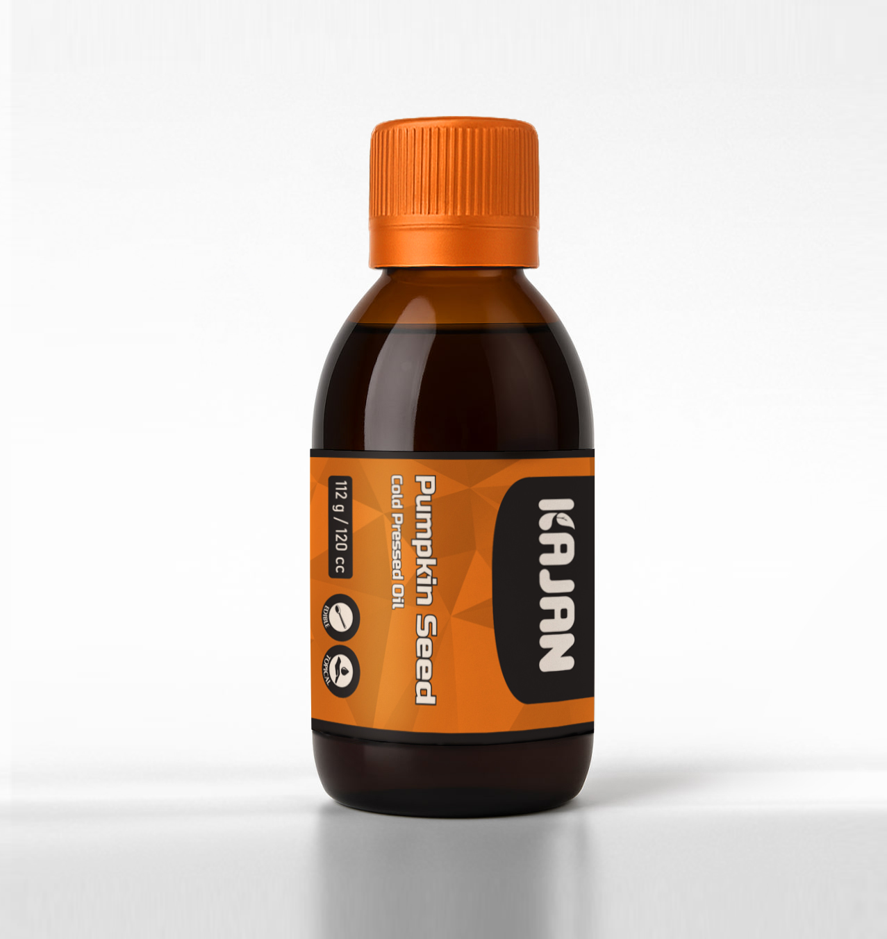 A clear bottle of 100% pure pumpkin seed oil with an orange and teal label, featuring the brand name “KAJAN.”