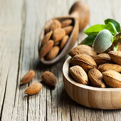  Sweet Almond are displayed in a wooden bowl on a wooden table